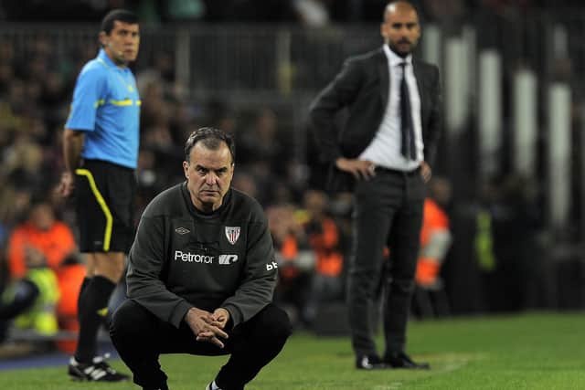 RIVALS: Athletic Bilbao's coach Marcelo Bielsa (down) and Barcelona's coach Josep Guardiola (R) on the touchline at the Camp Nou in March 2012. Picture: Lluis Gene/AFP via Getty Images)