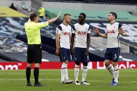 Controversy: Tottenham Hotspur players confront referee Peter Bankes after he awards a penalty against Eric Dier for handball. Picture: PA