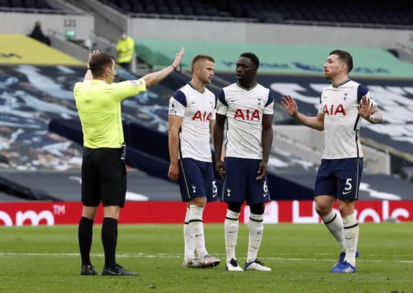 Controversy: Tottenham Hotspur players confront referee Peter Bankes after he awards a penalty against Eric Dier for handball. Picture: PA