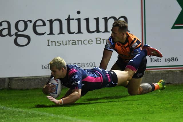 Castleford's Greg Eden can't stop Hull's Cameron Scott from scoring the game's first try.
