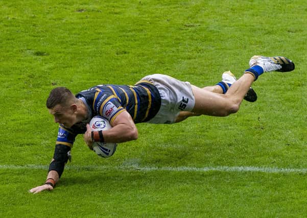 Ash splash: Ash Handley scores his first try in Rhinos Challenge Cup semi-final victory over Wigan at sodden St Helens.
 Picture Bruce Rollinson