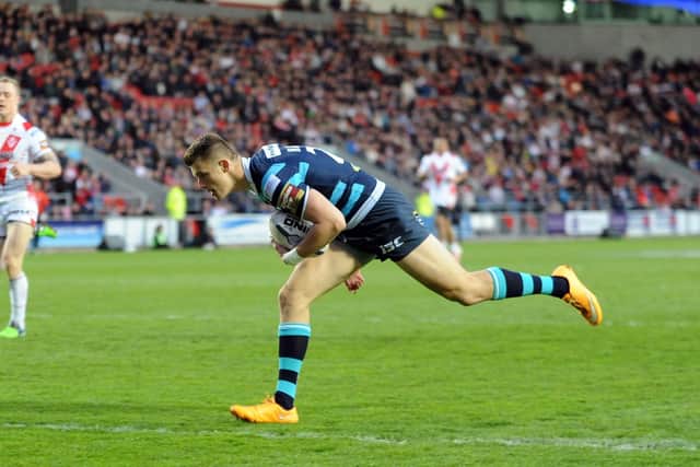 Ash Handley, pictured scoring a try against St Helens back in 2015, when the Rhinos won a treble.