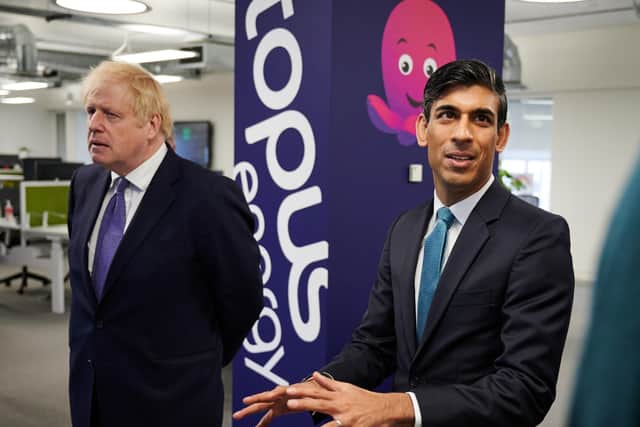 Prime Minister Boris Johnson and Chancellor of the Exchequer Rishi Sunak during a visit to the headquarters of Octopus Energy in London yesterday.