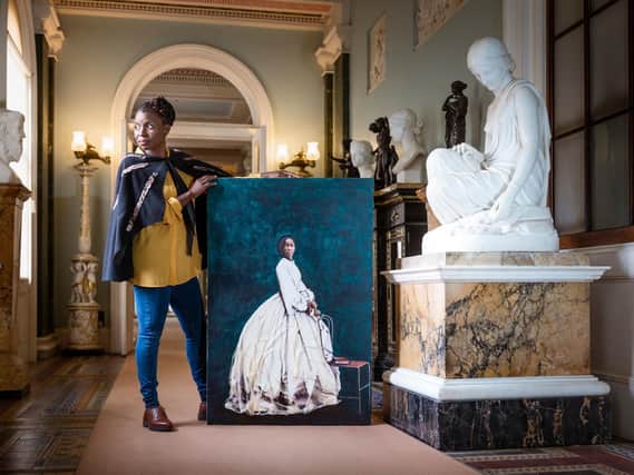 Hannah Uzor with her painting of Sarah Forbes Bonetta, Queen Victoria's African goddaughter, at Osborne. The organisation is displaying the portrait as part of a plan to feature works of overlooked black figures connected with its sites. Credit: Christopher Ison/English Heritage/PA Wire.