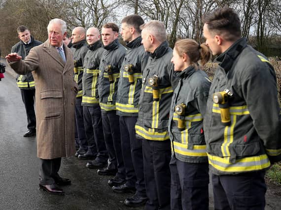 Prince Charles wearing the coat made for him in the 1970s by Anderson & Sheppard, during a visit in December last year to Fishlake, in South Yorkshire, which was hit by floods. Nigel Roddis/PA Wire