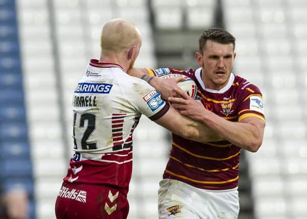 Huddersfield 
Giants Lee Gaskell tackled by Warriors Liam Farrell. (Picture: Tony Johnson)