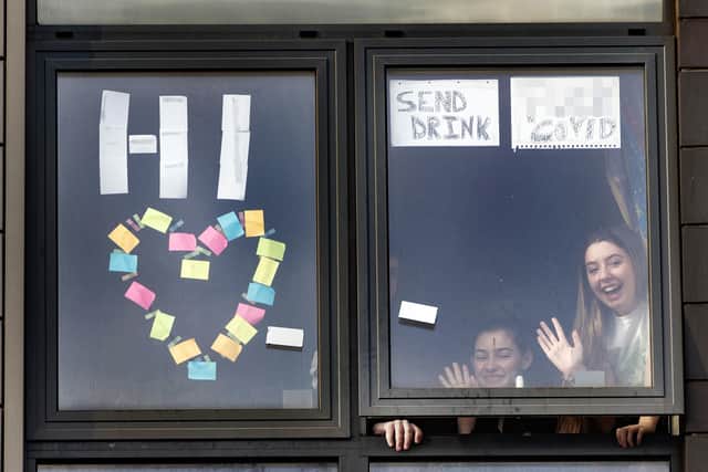 University students in lockdown stand by a widow in their halls of residence.