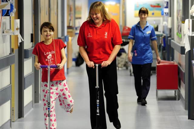 Lisa pictured in 2012 trying out a scotter with a child on the renal, liver and gastro ward.
 
Picture: 
rossparry.co.uk / Glen Minikin