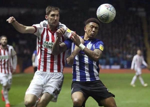 Sheffield United's Chris Basham (left) and Sheffield Wednesday's Liam Palmer battle in the Steel City derby in March 2019. Picture: Simon Cooper/PA