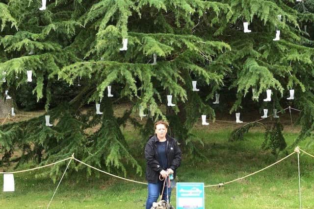 Fiona Green at Castle Howard with the tree covered in stainless steel wellies made by Anita