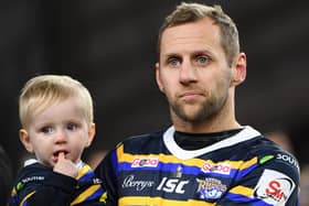 Warrior: 
Rob Burrow on the pitch with his son Jackson.
Picture: Jonathan Gawthorpe