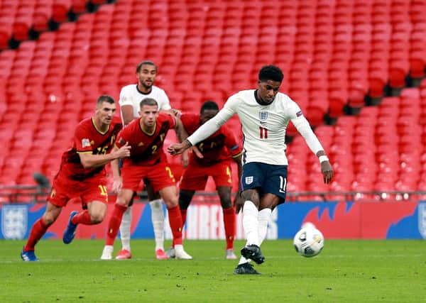 England's Marcus Rashford scores his side's first goal.