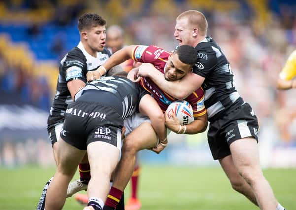 Huddersfield Giants' Darnell McIntosh is tackled by Hull FC's Joe Cator and Brad Fash of Hull FC in a clash between the two sides back in August. Picture by Isabel Pearce/SWpix.com