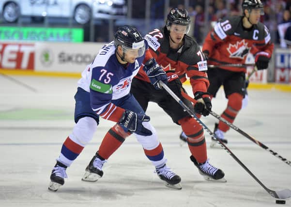Robert Dowd battles for possession for GB against Canada at last year'sWorld Championships. Picture: Dean Woolley.