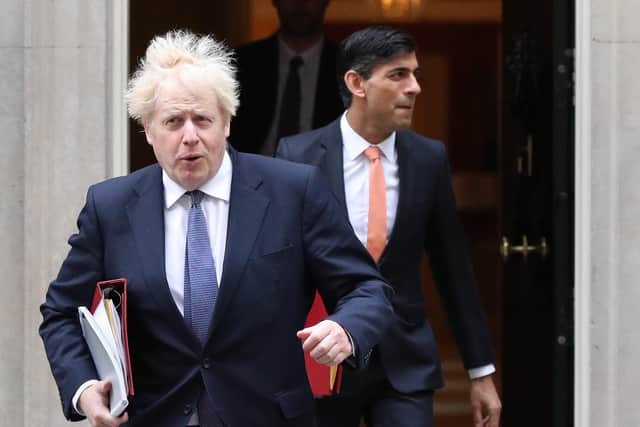 Boris Johnson and Rishi Sunak leave 10 Downing Street.