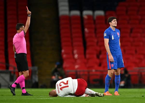 England's Harry Maguire is shown a red card for a foul on Denmark's Kasper Dolberg.