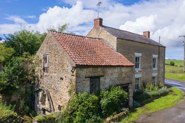 Heritage at Risk 2020. Coulton Mill, Scackleton Bank, Ryedale, Yorkshire.Aerial view from south showing water wheel on repaired south west elevation. Image: Historic England