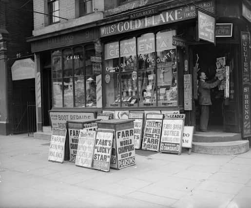 circa 1937:  Newsagent's shop with latest news placards outside.  (Photo by London Express/Getty Images)