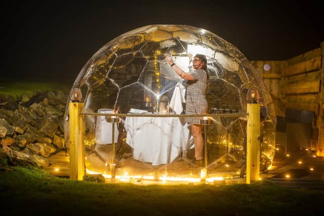 Pictured, Nicola Townsend duty manager at the Tan Hill Inn sets the table in the pods where diners can stargaze whilst enjoing their meal in private. Photo credit: Tony Johnson/ JPIMediaResell