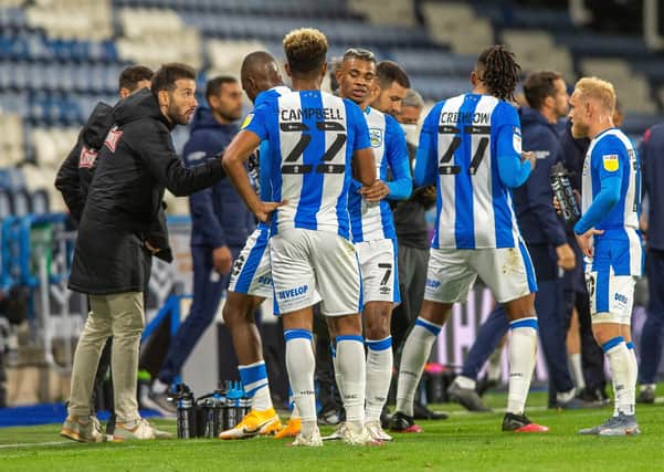 Carlos Corberan talks to his Huddersfield Town players.  Picture Bruce Rollinson