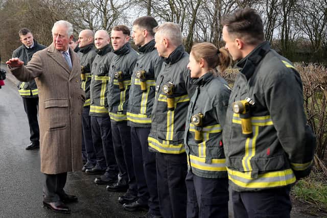 Prince Charles wearing the coat made for him in the 1970s by  Anderson & Sheppard,  during a visit in December last year to Fishlake, in South Yorkshire, which was hit by floods. Nigel Roddis/PA Wire