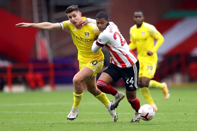 Battling for Blades: Record buy Rhian Brewster, right, challenges Fulham's Tom Cairney. Picture: PA