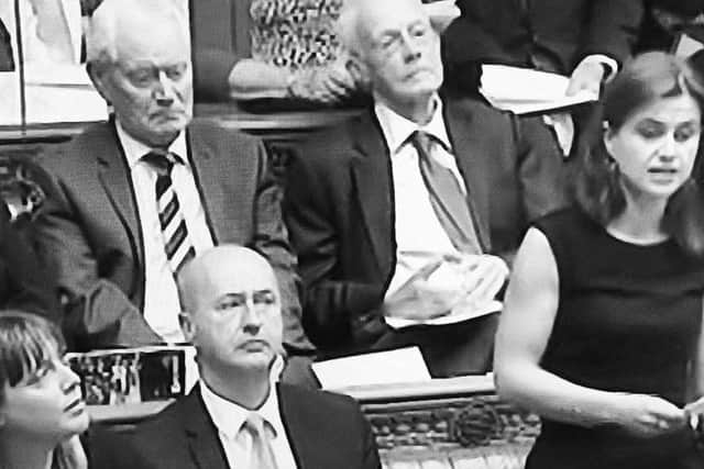 Phillips looks at Cox speaking in the House of Commons.