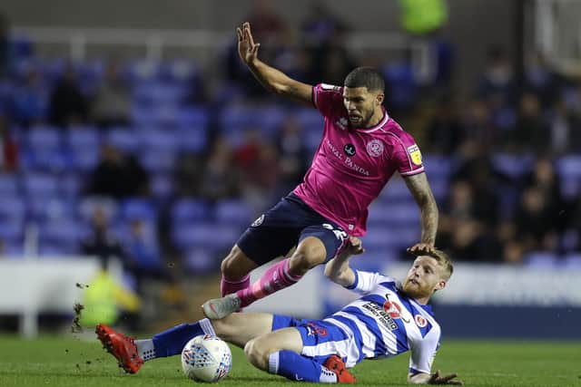 Queens Park Rangers's Nahki Wells (left) is tackled by Reading's Josh Sims during the Sky Bet Championship match in 2018 (Picture: PA)