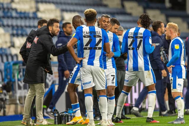 ON THE UP: Carlos Corberan talks to his Huddersfield Town team during a break in the match against Nottingham Forest Picture: Bruce Rollinson