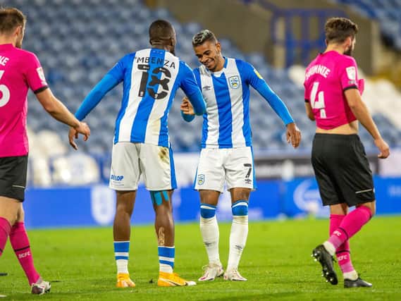Huddersfield Town scorer Juninho Bacuna takes the congratulations from team-mate Isaac Mbenza after his goal. Picture: Bruce Rollinson.