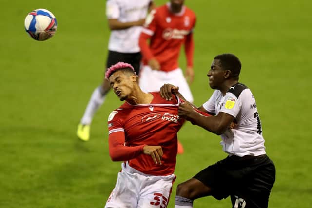 Nottingham Forest's Lyle Taylor and Rotherham's Wes Harding compete in the air (Picture: PA)