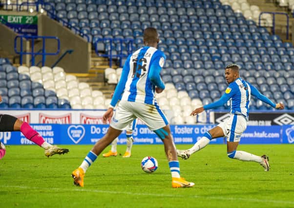 On target: Juninho Bacuna strikes home Huddersfield's winner. Picture Bruce Rollinson