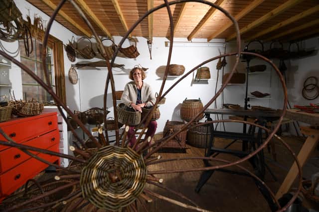 Angela is pictured at work in her workshop weaving baskets out of willow.Picture by Simon Hulme