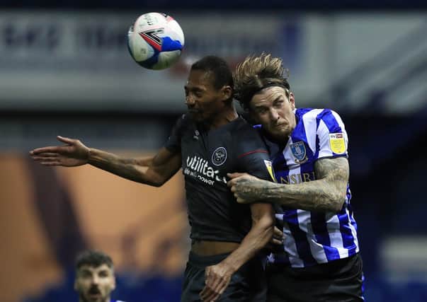 Brentford's Ethan Pinnock and Sheffield Wednesday's Aden Flint. Picture: PA.