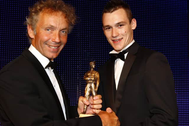 Rhys Flint collects an award from John Francome, the former champion jockey, after being named conditional rider of the year.