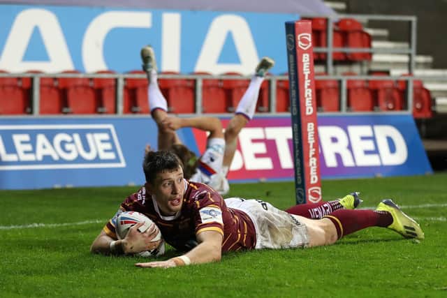 Not enough: Huddersfield's Sam Wood scores his side's third try but the Giants still lost. Picture: PA