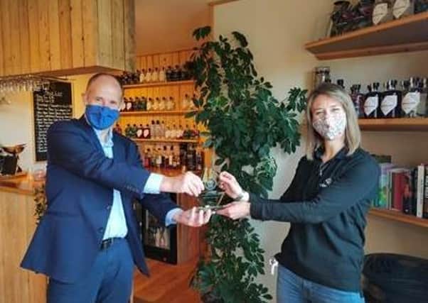 MP Kevin Hollinrake presenting Dr Abbie Neilson, co-founder of Cooper King Distillery, with a Community Spirit Award from the  UK Spirits Alliance.