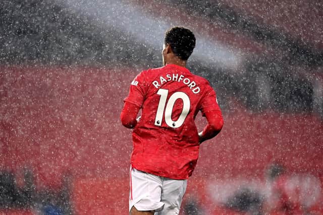 Manchester United's Marcus Rashford in the rain during the Premier League match at Old Trafford, Manchester, as he stepped up his campaign against child food poverty.