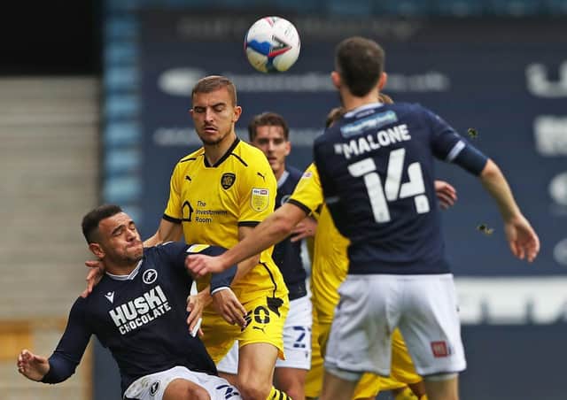 Millwall's Mason Bennett (left) and Barnsley's Michal Helik (right) battle for the ball (Picture: PA)
