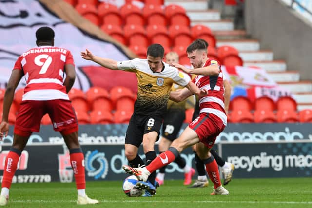 Doncaster's Ben Whiteman tussles with Tom Lowery of Crewe (Picture: Howard Roe/AHPIX LTD
)