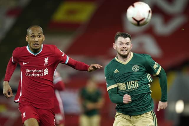 Liverpool's Fabinho tussles with Sheffield United's Oliver Burke at Anfield. Picture: Andrew Yates/Sportimage