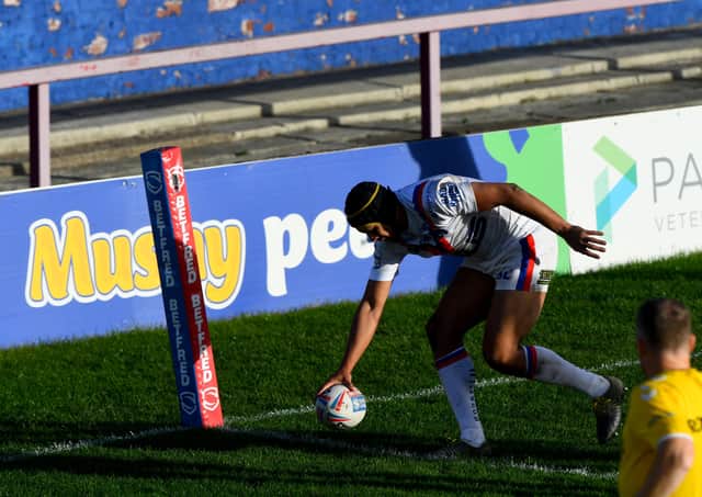 Over and out: Wakefield winger Ben Jones-Bishop crosses for his hat-trick try in Trinity’s 48-18 thrashing of Betfred Super League rivals Hull KR yesterday.Picture: James Hardisty