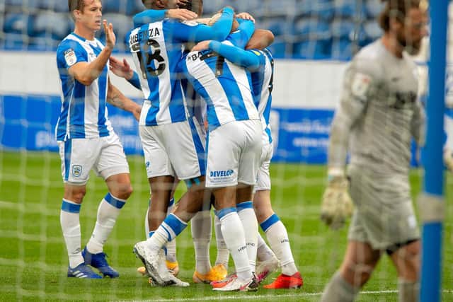 HIGH SPIRITS: Huddersfield Town players celebrate going 1-0 up against Preston North End. Picture: Bruce Rollinson.
