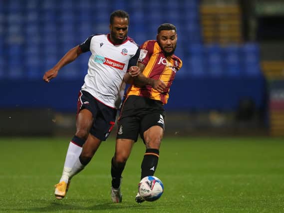 BATTLING: Bolton goalscorer Nathan Delfouneso and Bradford's Ben Richards-Everton challenge for the ball. Picture: Charlotte Tattersall/Getty Images.