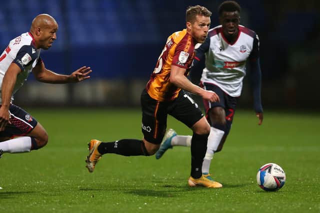 GETTING FORWARD: Bill Clarke looks to get away from the Bolton defenders. Picture: Charlotte Tattersall/Getty Images.