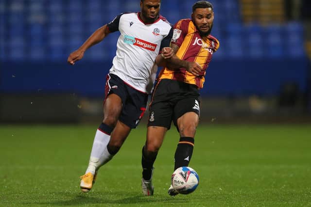 BATTLING: Bolton goalscorer Nathan Delfouneso and Bradford's Ben Richards-Everton challenge for the ball. Picture: Charlotte Tattersall/Getty Images.