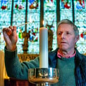 Tom Ramsden lights a candle at Ripon Cathedral in memory of his father, the Rt. Hon James Ramsden ahead of the service for the bereaved