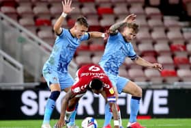 Middlesbrough's Britt Assombalonga (centre) battles for the ball with Coventry City's Leo Ostigard (left) and Kyle McFadzean at Riverside Stadium on Tuesday night. Picture: Richard Sellers/PA