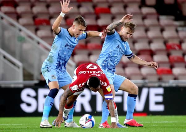 Middlesbrough's Britt Assombalonga (centre) battles for the ball with Coventry City's Leo Ostigard (left) and Kyle McFadzean at Riverside Stadium on Tuesday night. Picture: Richard Sellers/PA