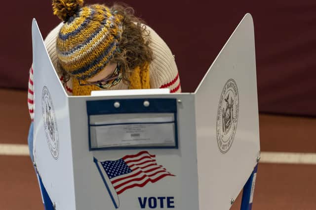 A voter marks her ballot during early voting at the Park Slope Armory YMCA, Tuesday, Oct. 27, 2020, in the Brooklyn borough of New York. w